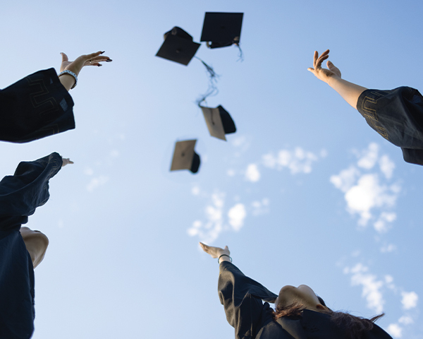 Graduates tossing caps